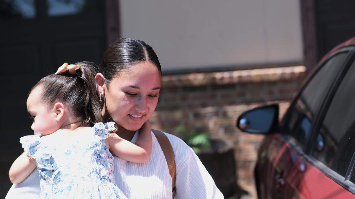 Isabel Yara holds her daughter and takes her to the car for her daughter’s doctor’s appointment. Living in rural Kansas means her doctor is an hour away.
