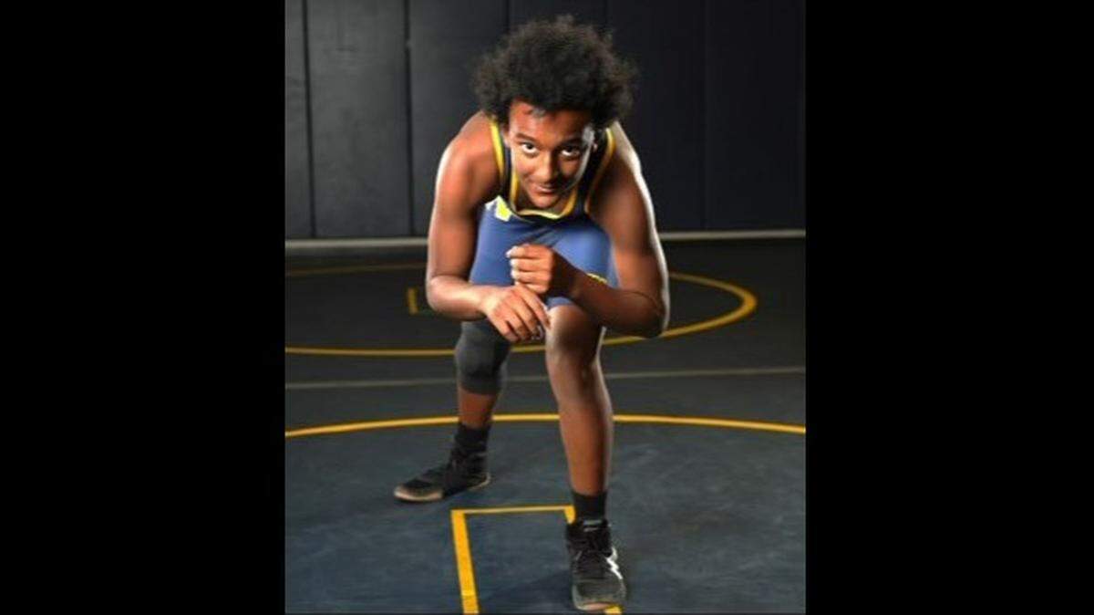 Claude Hodges Jr. poses for a photo in November in the Northwest High School wrestling room. The 14-year-old freshman was found fatally wounded in his mother’s west Wichita apartment last month. His mother, 43-year-old Kylee Renee Reynolds-Hodges, was arrested Monday on suspicion of first-degree murder.