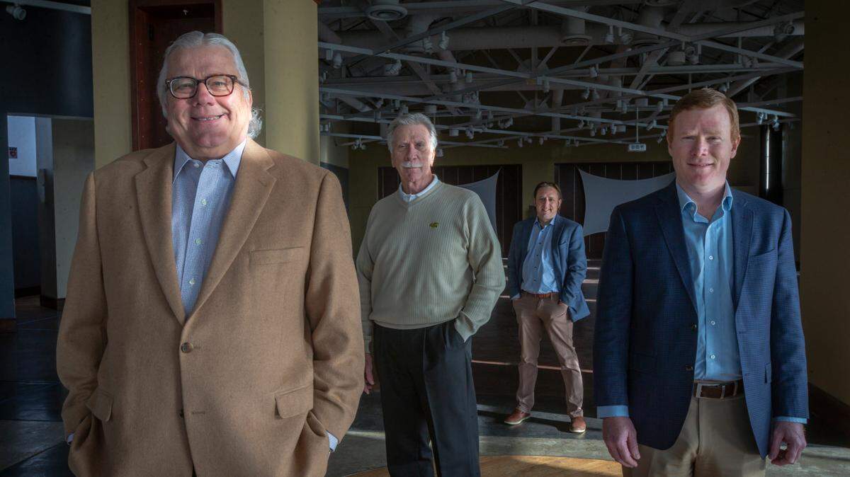 Martens Cos. is remaining in its longtime downtown space, but the commercial brokerage firm NAI Martens is moving to the former Abode Venue in the heart of the Douglas Design District. Pictured in the new space are, from left, Steve Martens, Tom Johnson, Jeff Englert and Grant Glasgow.