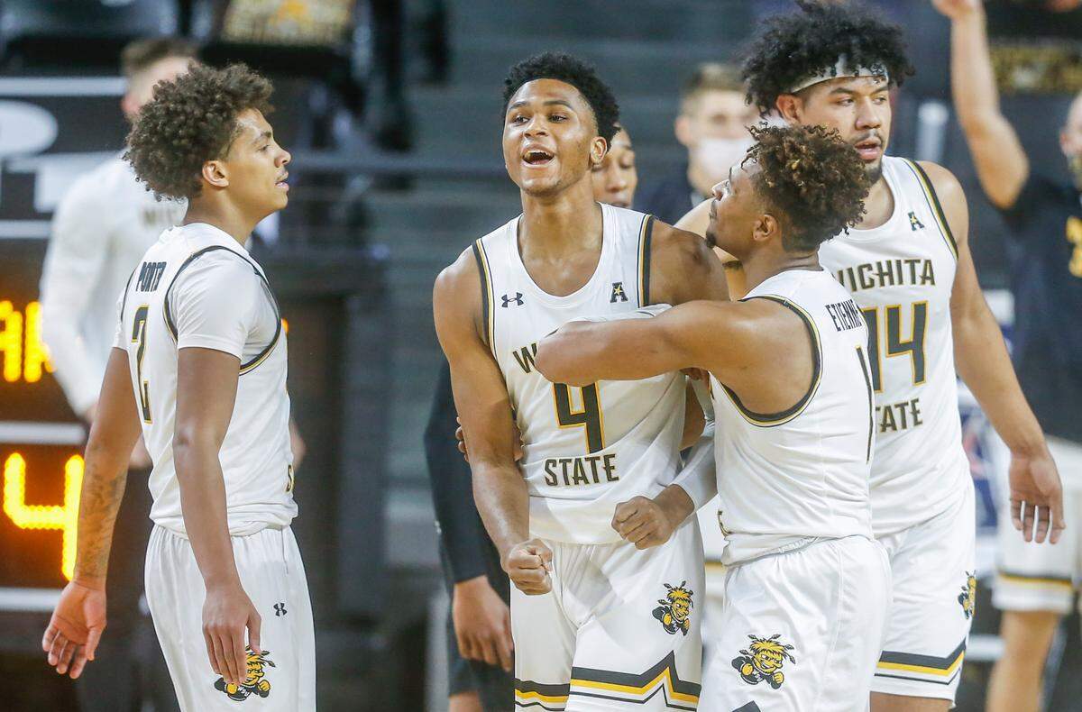 Wichita State’s Ricky Council IV is congratulated by teammates after picking up a foul and basket against Cincinnati on Sunday at Koch Arena.