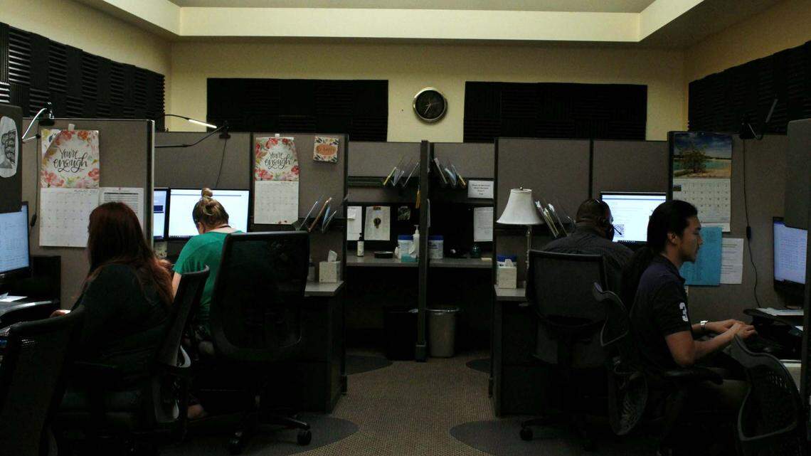 Call takers answer the phone inside Sedgwick County’s mental health crisis center.