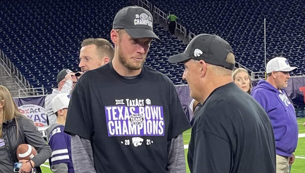 Kansas State assistant coach Collin Klein speaks with Chris Klieman after the Wildcats beat LSU at the Texas Bowl.