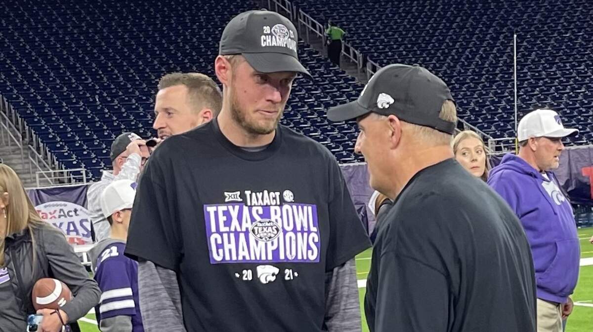 Kansas State assistant coach Collin Klein speaks with Chris Klieman after the Wildcats beat LSU at the Texas Bowl.