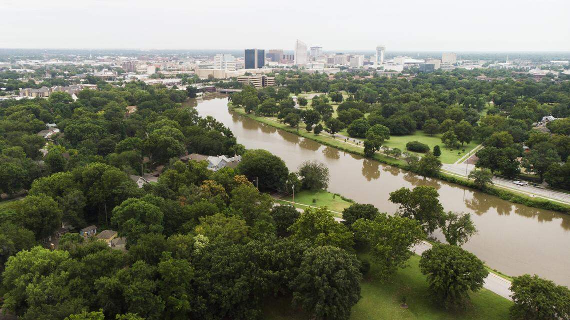 A view of downtown Wichita with Central Riverside Park and the Little Arkansas River in the foreground. 