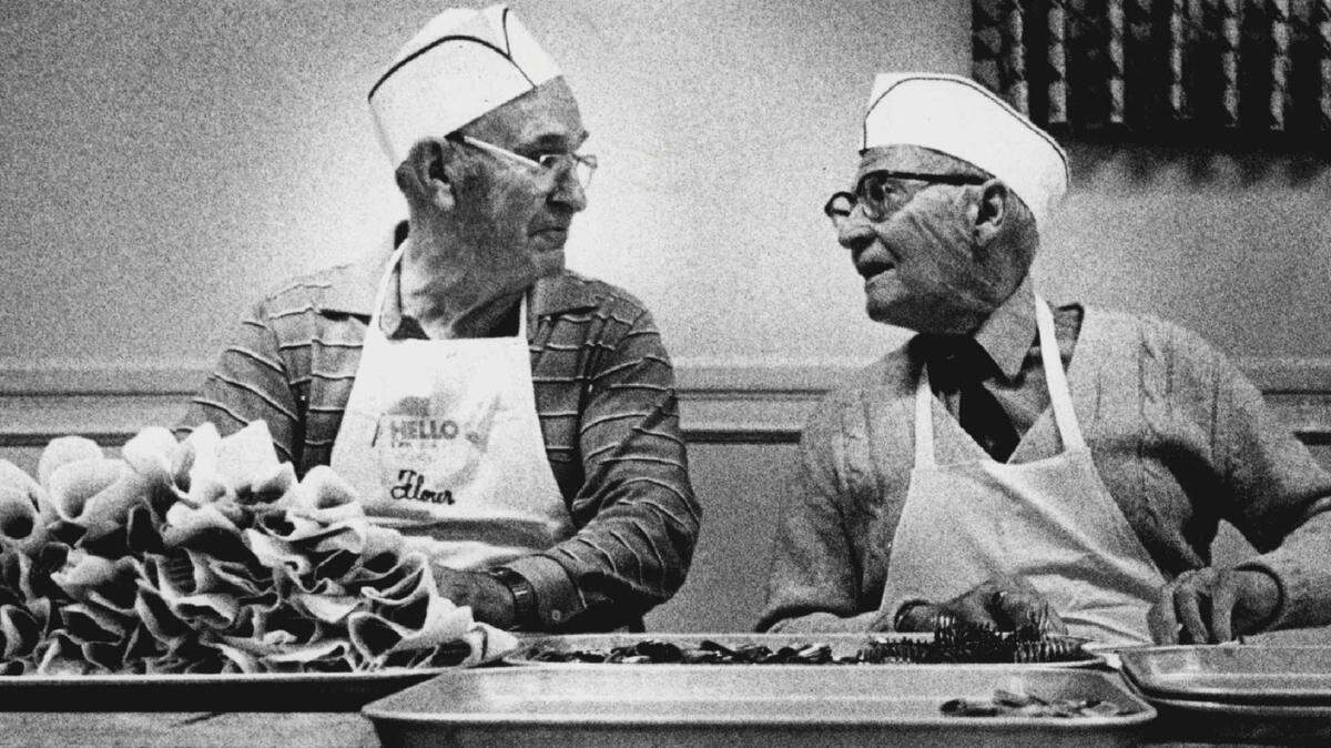 Gerald Tague and Ed Miller are pictured working at the 1986 dinner.