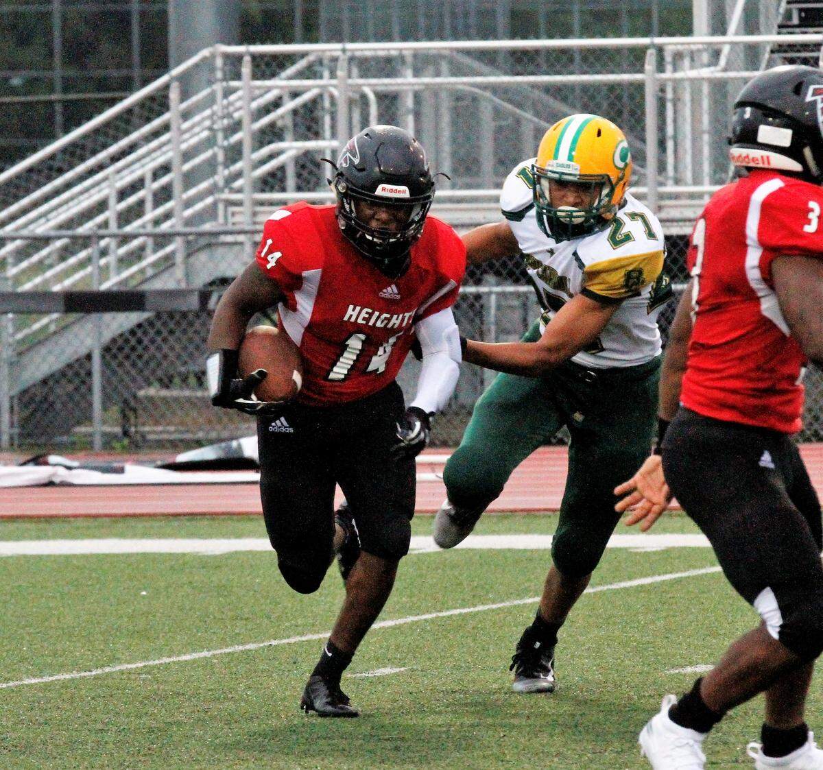 Armaad Hubbard, a Wichita Heights senior running back, runs away from Bishop Carroll defenders in the Golden Eagles’ 36-20 win over the Falcons on Friday. (Sept. 7, 2018)