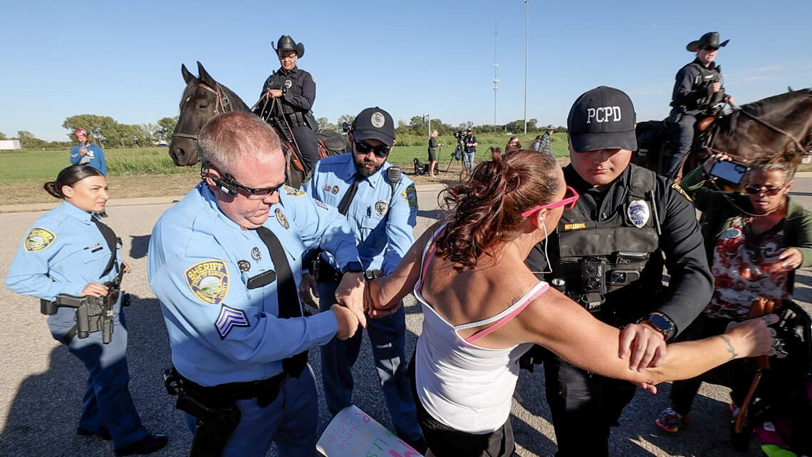One woman arrested while protesting before Trump rally
