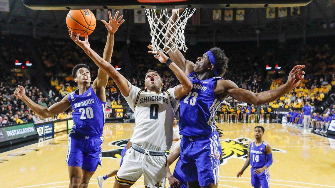 Dexter Dennis tries to get a shot off against Memphis center Malcolm Dandridge, right, and Josh Minott during the second half on Saturday at Koch Arena.