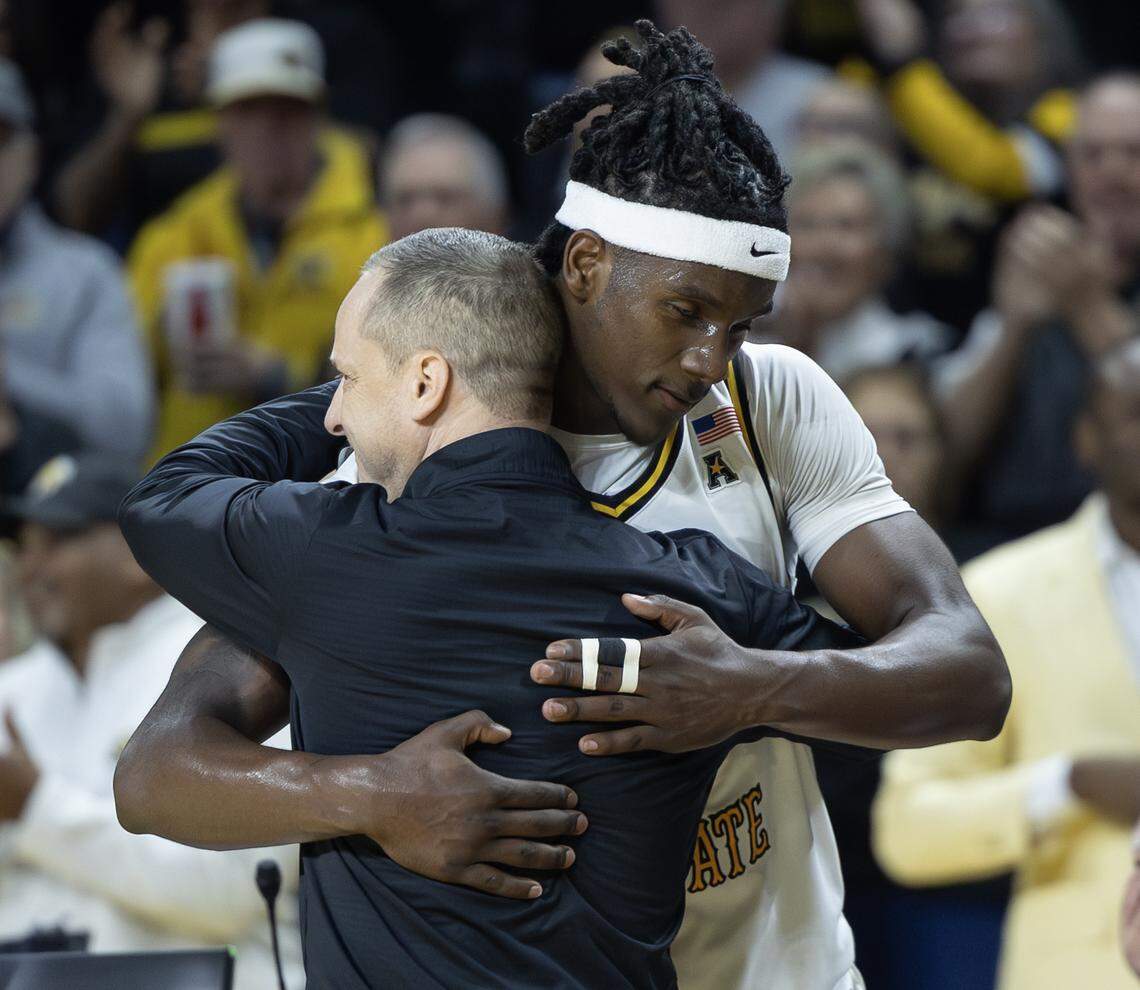 Wichita State’s Karon Boyd hugs head coach Paul Mills after he was taken out of the game against Florida Atlantic late in the second half on Saturday.