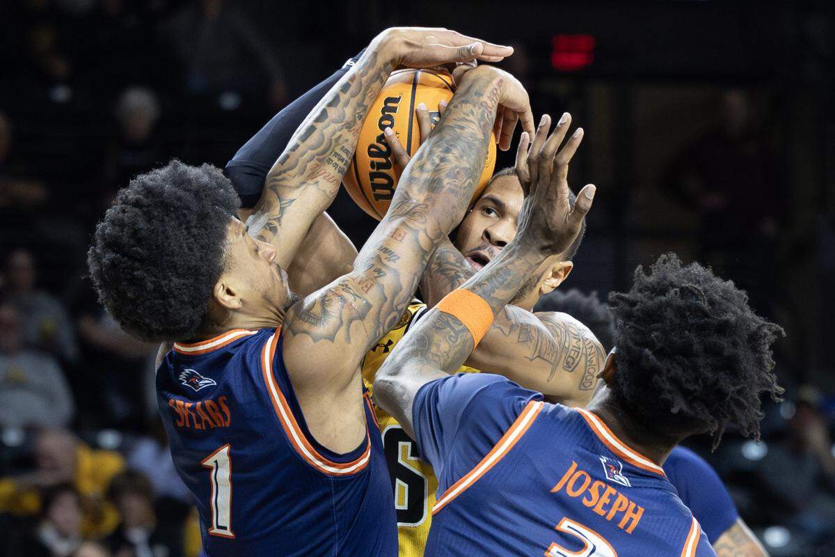Wichita State’s Corey Washington is swarmed by UTSA defenders during the first half of their game at Koch Arena on Wednesday night. 