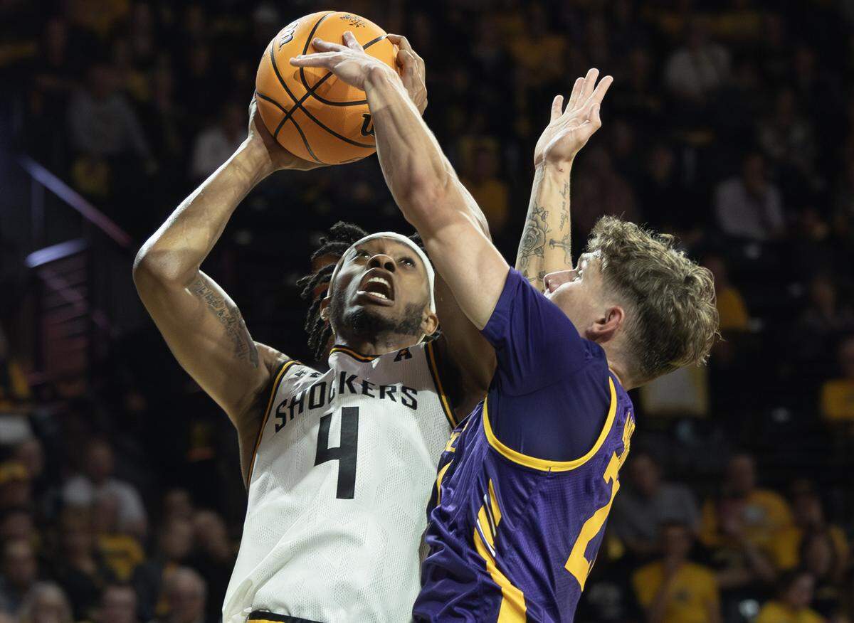 Wichita State’s Colby Rogers drives to the basket against Lipscomb’s Joe Anderson during the first half of their season opener on Monday night at Koch Arena. Rogers poured in 18 points in the first half in his first official game as a Shocker.