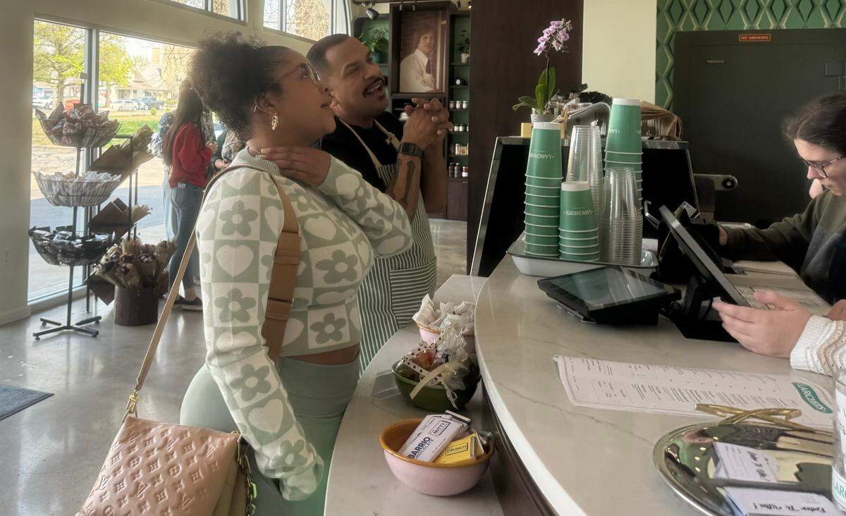 Chef Kevin Lebron helps a customer decide what to order at the new Larcher’s Market, where he serves as operations director.