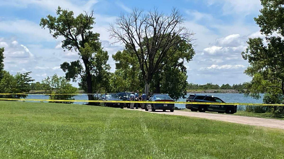 Sedgwick County Sheriff’s Office deputies and investigators taped off a camping area of Lake Afton after the bodies of two men were recovered from the water Sunday.