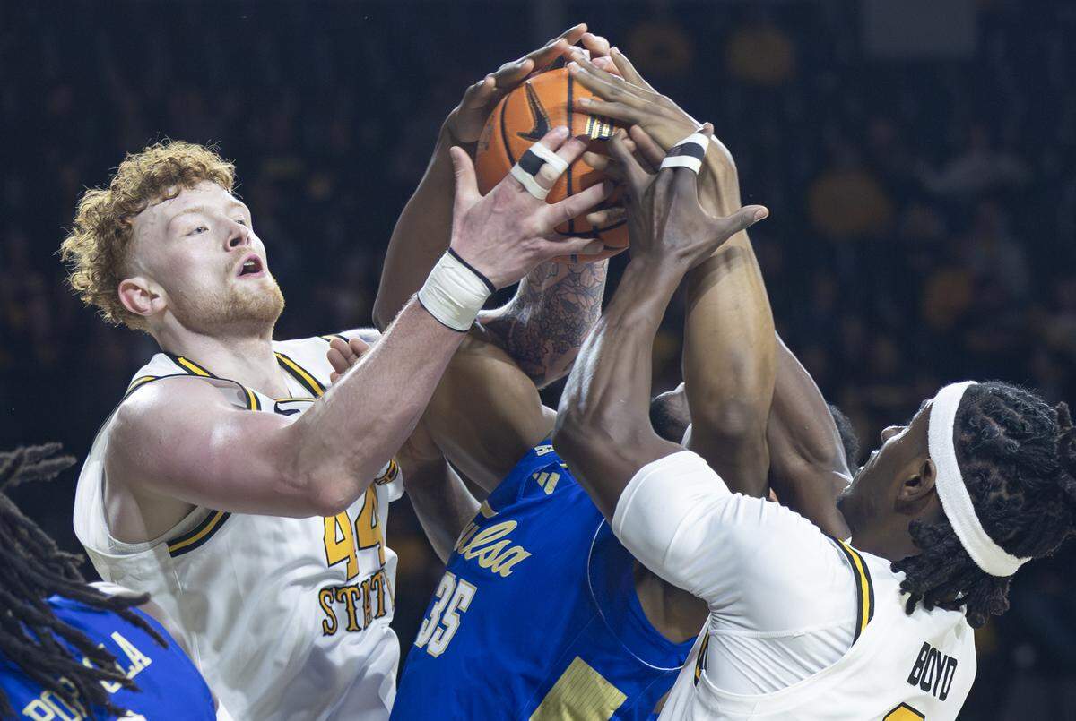 Wichita State’s Will Berg, left, and Karon Boyd, right, fight for a rebound with Tulsa’s Ian Smikle during the first half at Koch Arena on Saturday night.