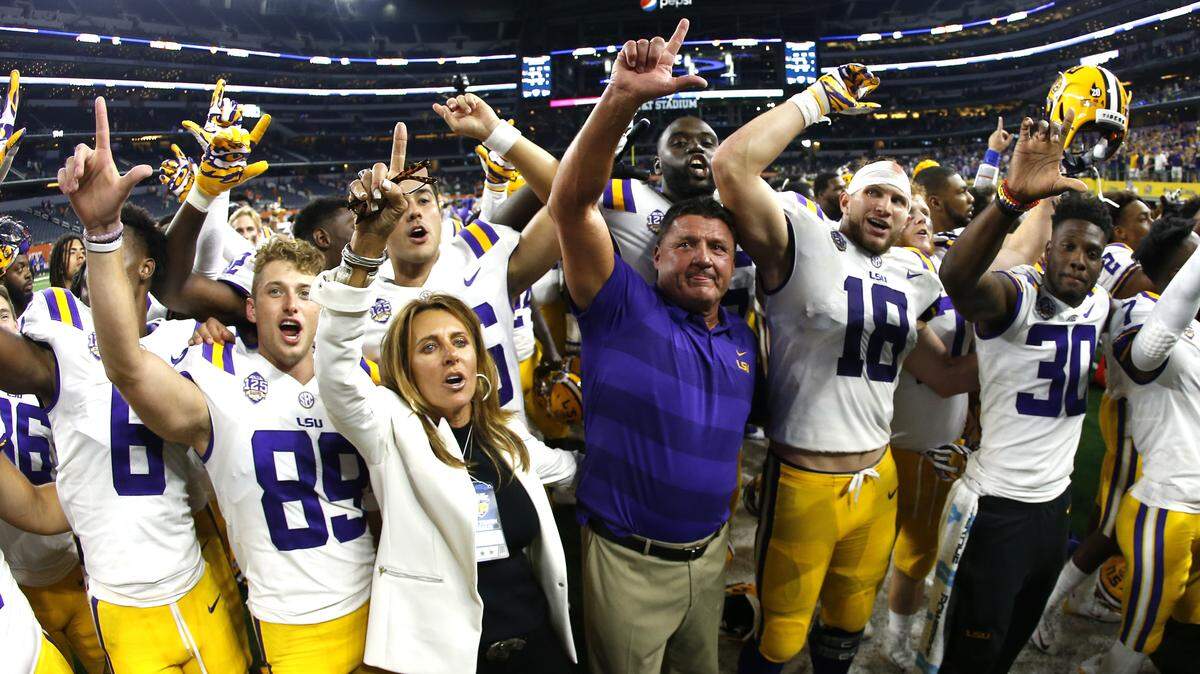 LSU head coach Ed Orgeron celebrates with his team following their 33-17 win over LSU in an NCAA college football game Sunday, Sept. 2, 2018, in Arlington, Texas. (AP Photo/Ron Jenkins)