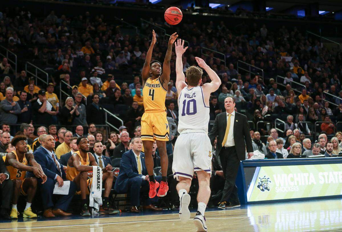 Wichita State’s Samajae Haynes-Jones hits a three-pointer over Lipscomb’s Jake Wolfe during the second half on Tuesday during the NIT semifinals at Madison Square Garden on Tuesday. 