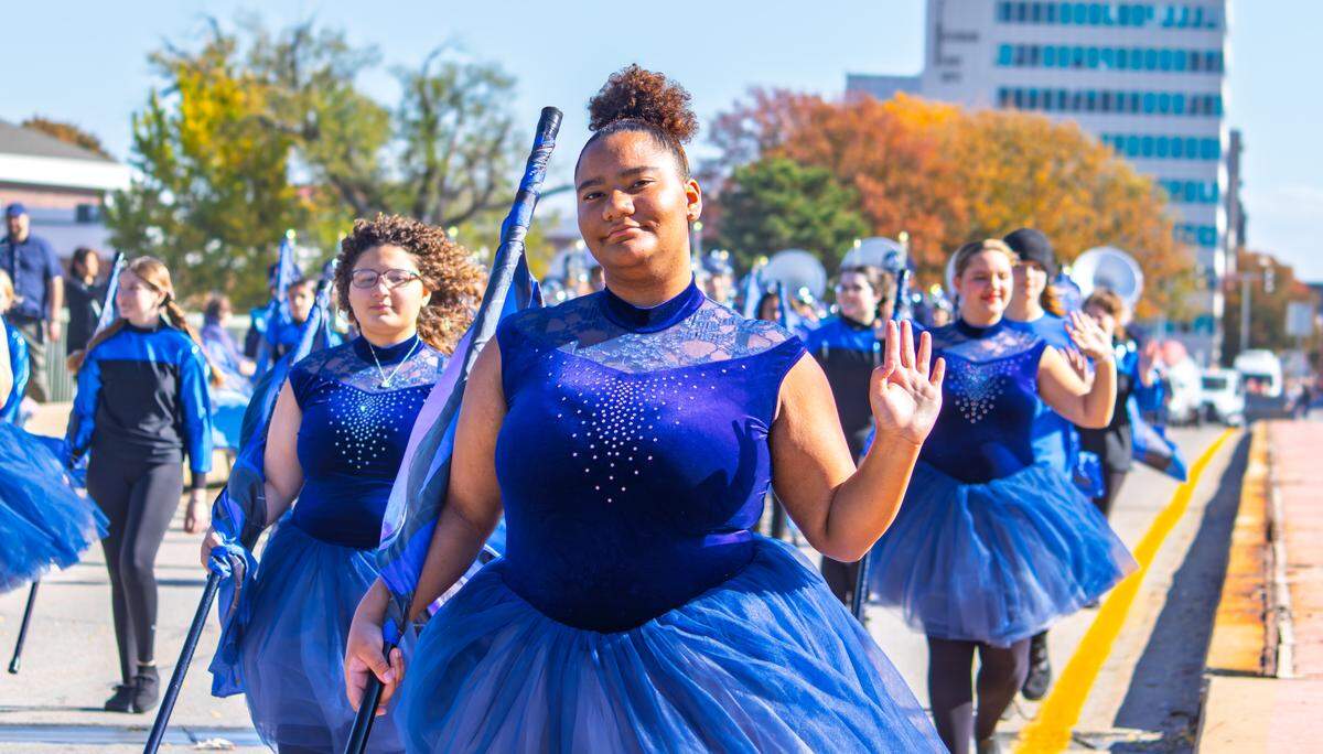 Members of a Wichita high school twirling team wave while walking in Wichita's Veterans Day parade on Nov. 8.