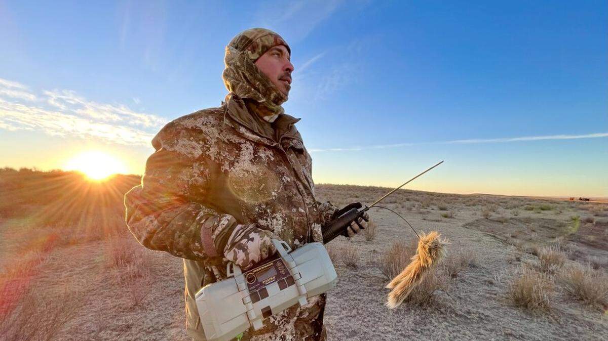 Coyote caller Bryan Garrison, who also runs the contest in Kismet, holds his electronic calling machine and a motorized decoy.