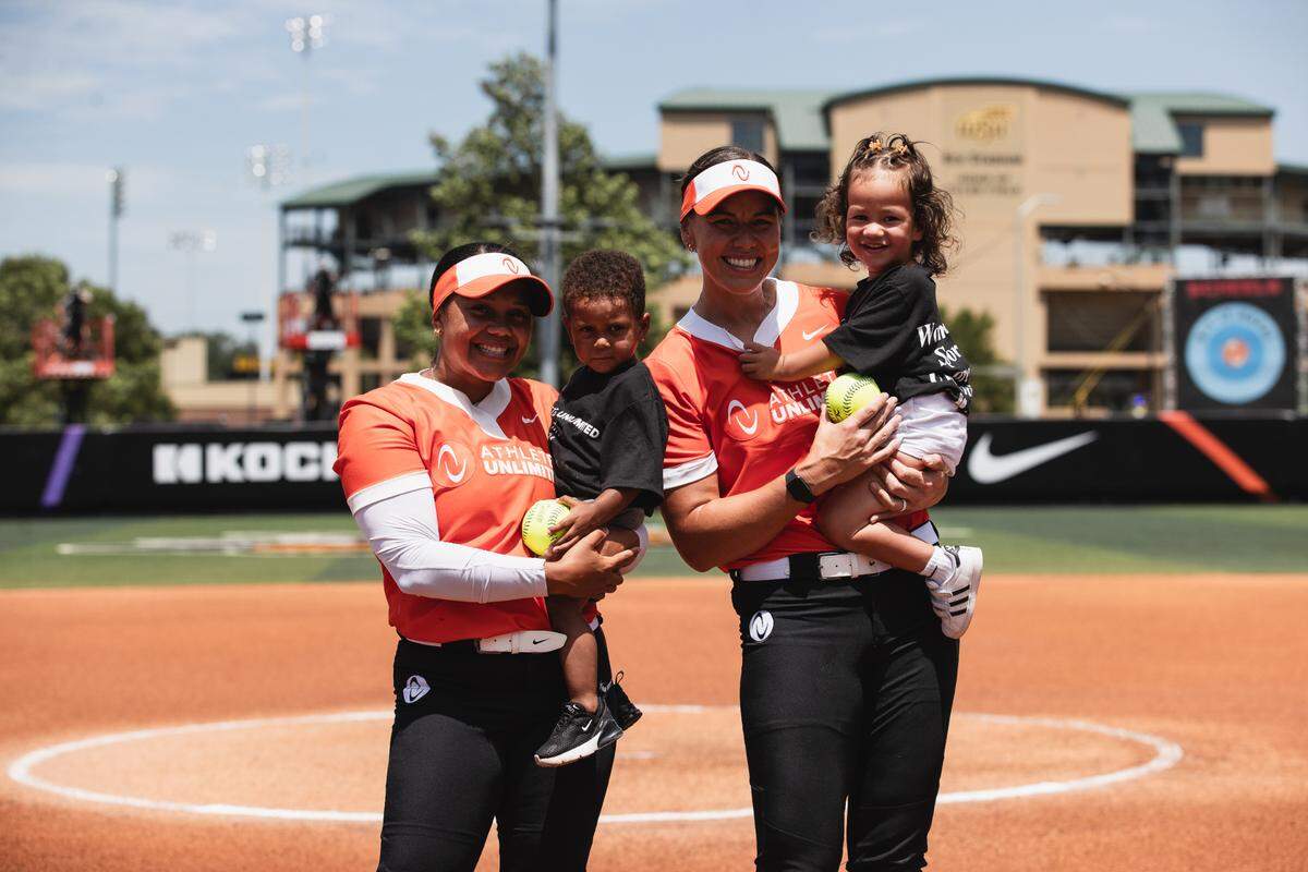 Maize graduate Kelsey Stewart-Hunter (left) and her son poses for a picture following a AUX Softball game at Wilkins Stadium in Wichita this summer.