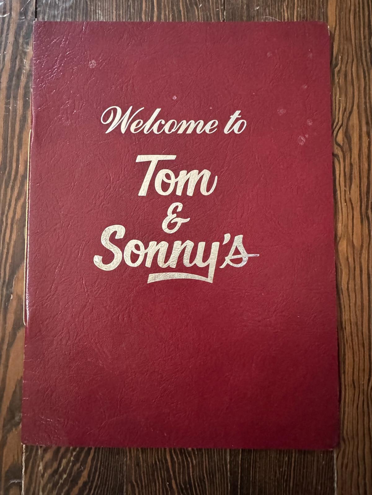 The cover of an old menu from Tom & Sonny’s, a restaurant and club that operated at Douglas and West Street from 1979 to 1989
