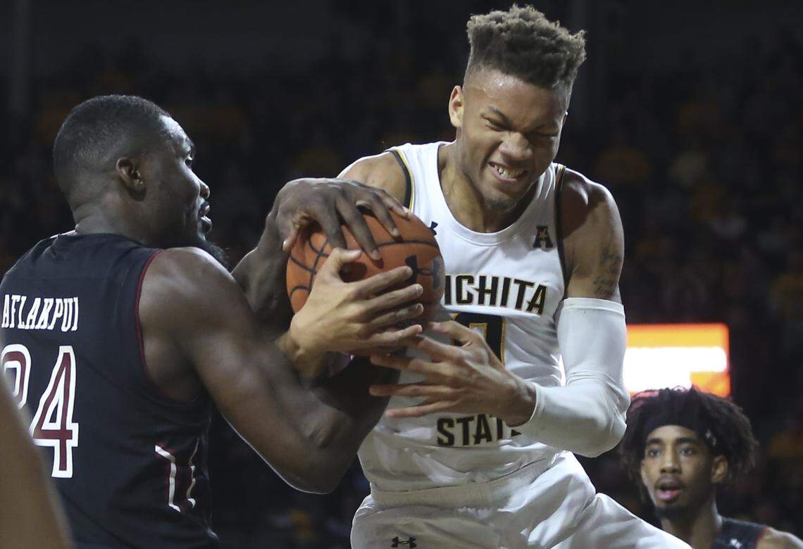 Wichita State guard Dexter Dennis fights for a rebound against Temple center Ernest Aflakpui during overtime on Sunday. 