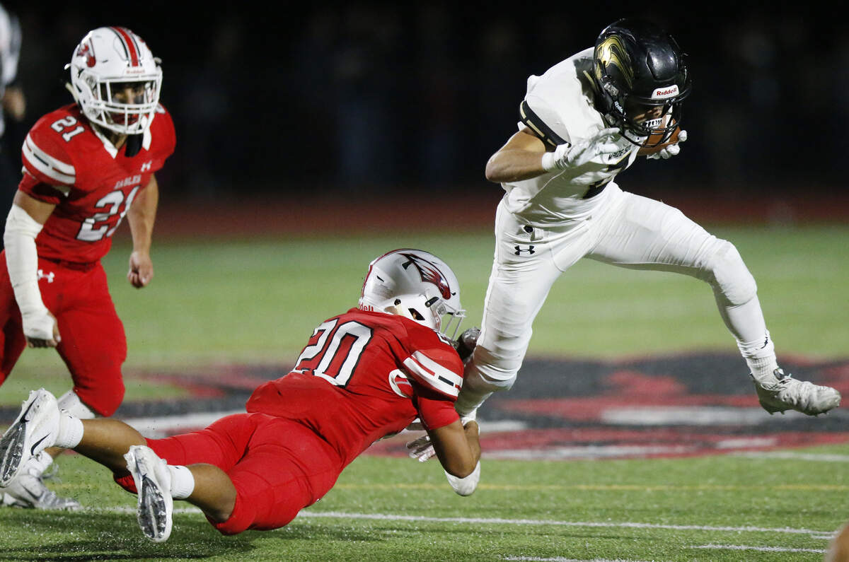 Maize South #2 Corey Minks looks for a safe path as Maize defender #20 Adrian Triana dives at his legs. (November 2, 2018)