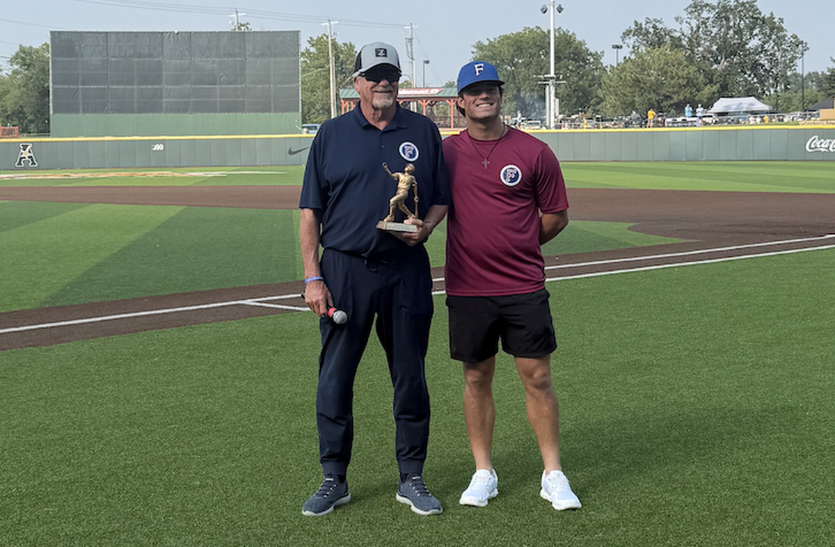 Santa Barbara Foresters manager Bill Pintard awards his own player, Mic Paul, the NBC World Series Most Inspirational award named after his son.