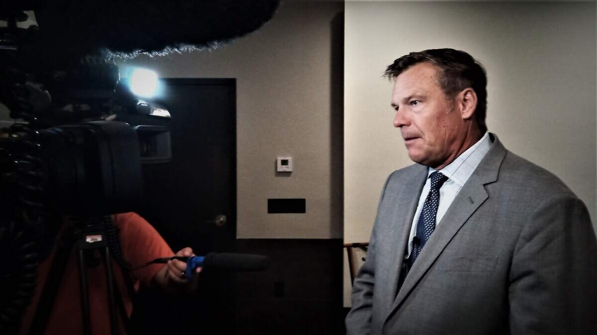 Kansas Attorney General Kris Kobach fields questions from reporters after a meeting of the Wichita Crime Commission.