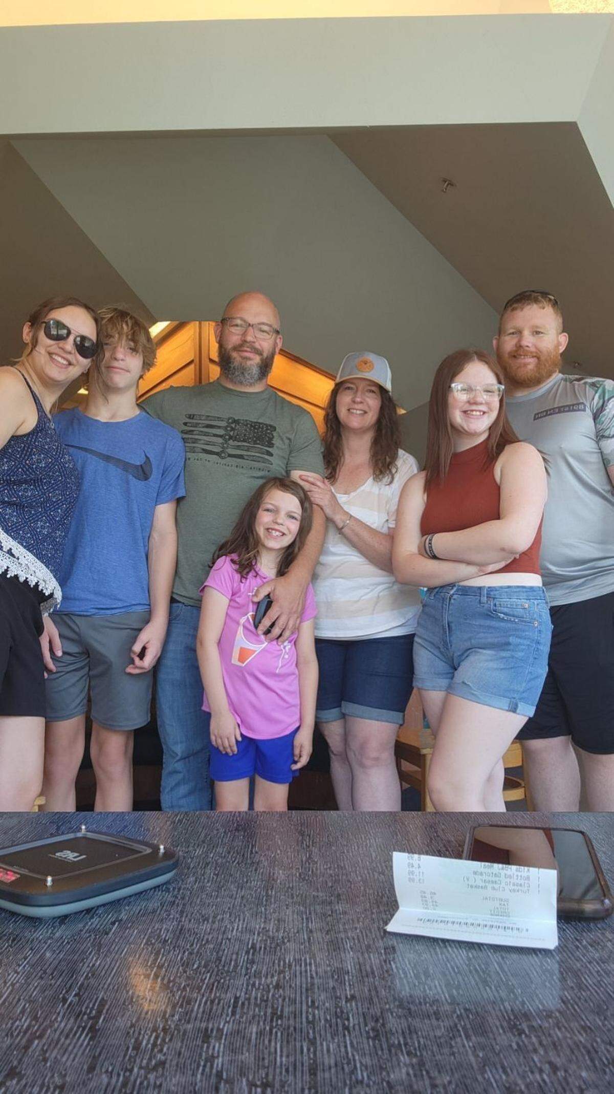 The Hubbard family is opening Cuppa Yo, a frozen yogurt franchise, in Andover. The family includes, from left, oldest daughter Destiny Hoard, son Cyrus, father Justin, youngest daughter Mila (in purple shirt), mother Catrina, granddaughter Evee Hoard and son-in-law Jason Hoard, who is married to Destiny.