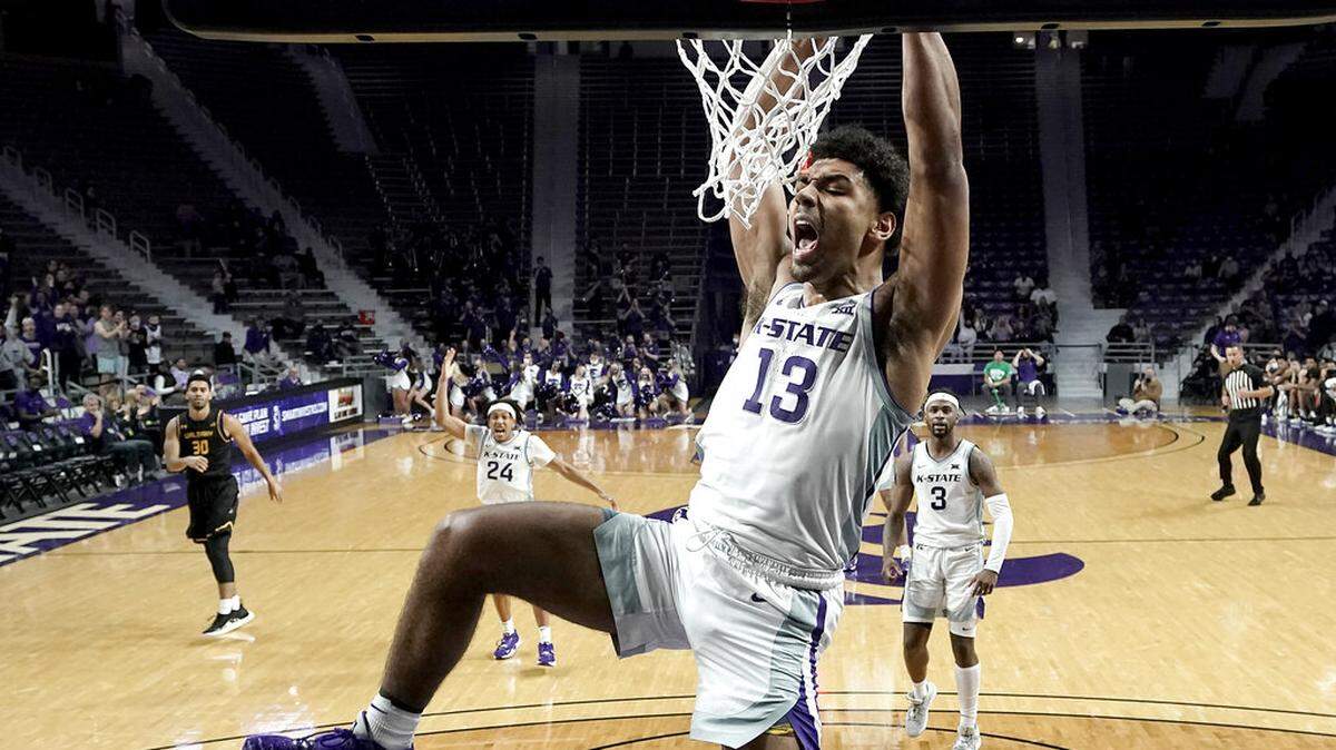 Kansas State’s Mark Smith (13) celebrates after dunking the ball during the second half of an NCAA college basketball game against Albany Wednesday, Dec. 1, 2021, in Manhattan, Kan. (AP Photo/Charlie Riedel)