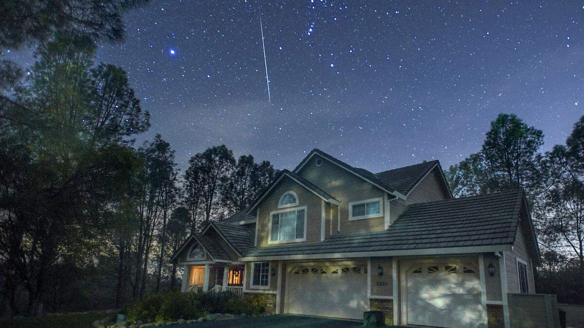 A meteor streaks across the sky during the annual Geminid meteor shower in El Dorado, Calif., on Dec. 14, 2017. It is produced by debris left behind by an asteroid known as 3200 Phaethon.