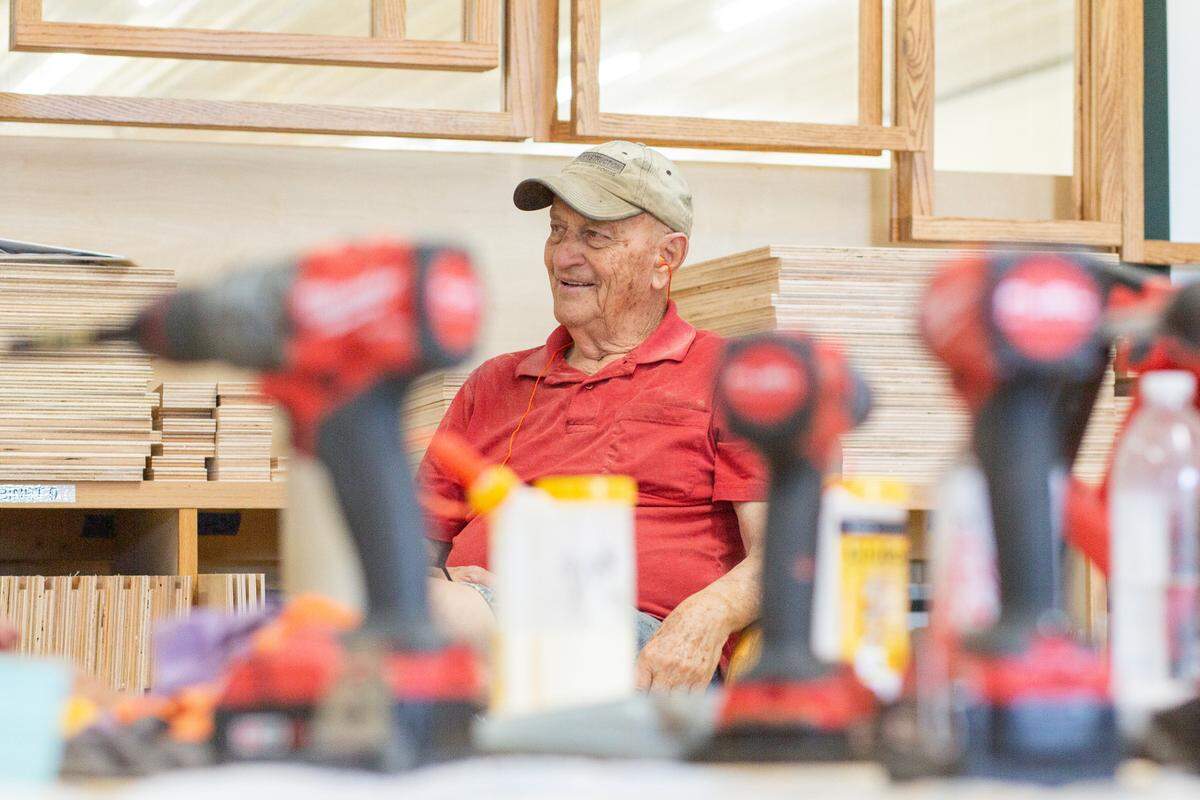 Ron “Flick” Flickinger talks and laughs with other volunteers at the Kansas unit of the Mennonite Disaster Service. Flickinger is a retired civil service worker, meat inspector and mailman. In his free time, he likes to work with wood.