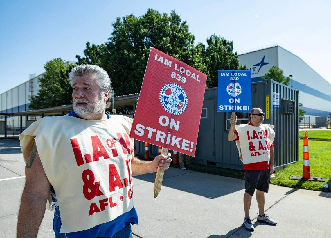 Striking workers Tony Mower, left, and Jesus Luan picket outside the Spirit AeroSystems factory on Saturday morning. Members of the Machinists union voted down a proposed contract from Spirit earlier this week and voted to strike.