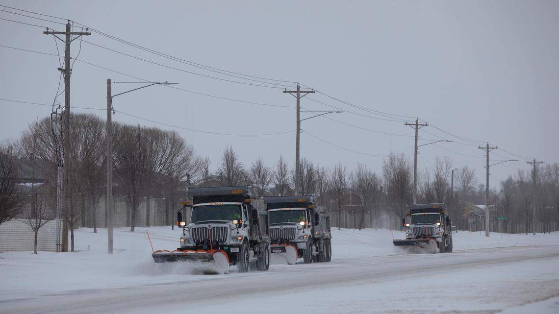 A trio of snow plowers clear 135th St. W near 13th St.(February 2, 2022)