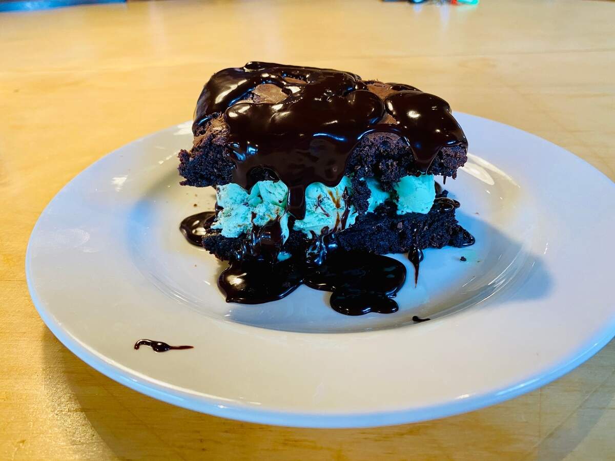 A decadent ice cream sandwich stuffed with mint chocolate chip ice cream is one of the dessert options at Chef’s Table Roadhouse.