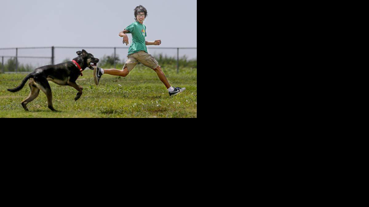 Fourteen-year-old Dominic Suniga exercises with his dog Brutus at the Murfin Animal Care Campus Dog Park on Saturday. 


