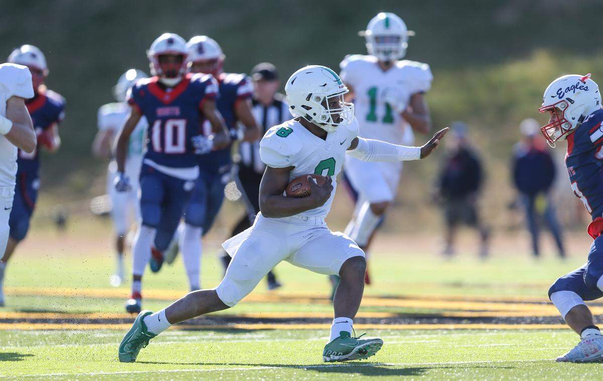 Derby’s Lem Wash jukes an Olathe North defender on his way to a touchdown in the 3rd quarter of the 6A state title game in Emporia.