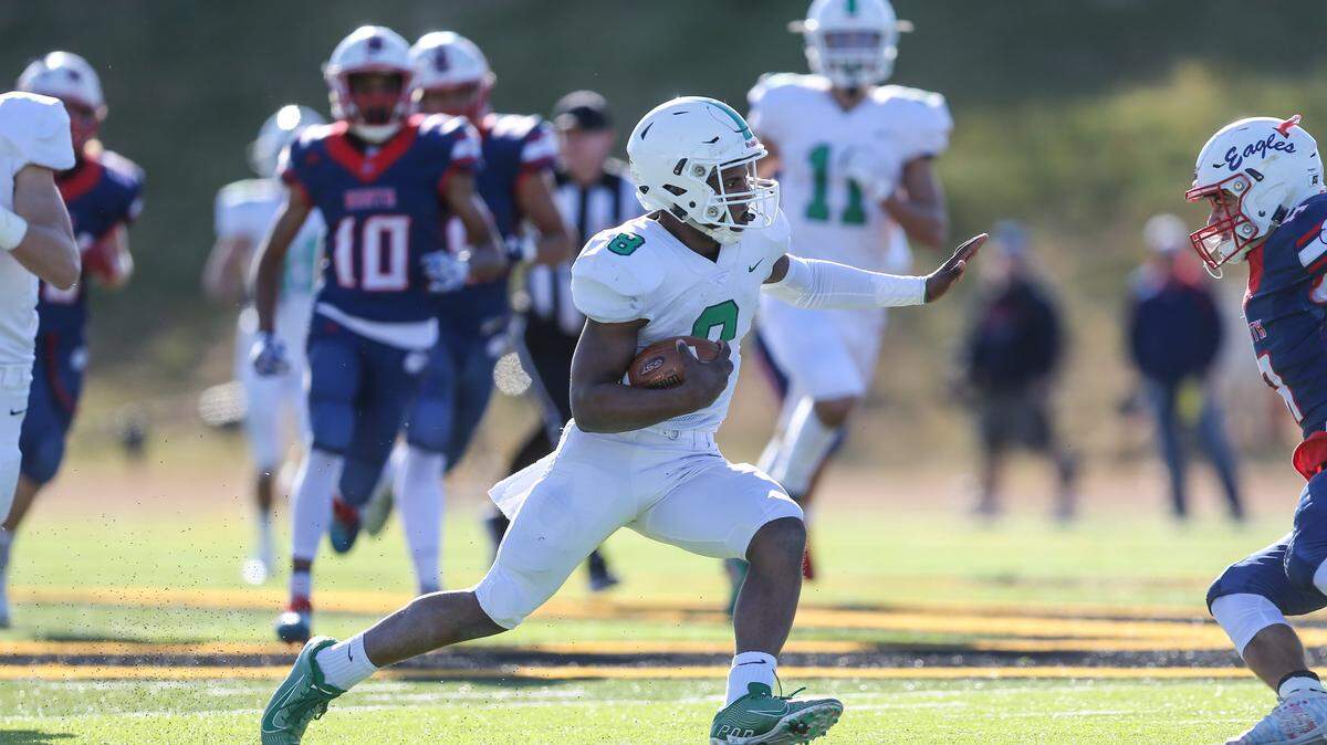 Derby’s Lem Wash jukes an Olathe North defender on his way to a touchdown in the 3rd quarter of the 6A state title game in Emporia.