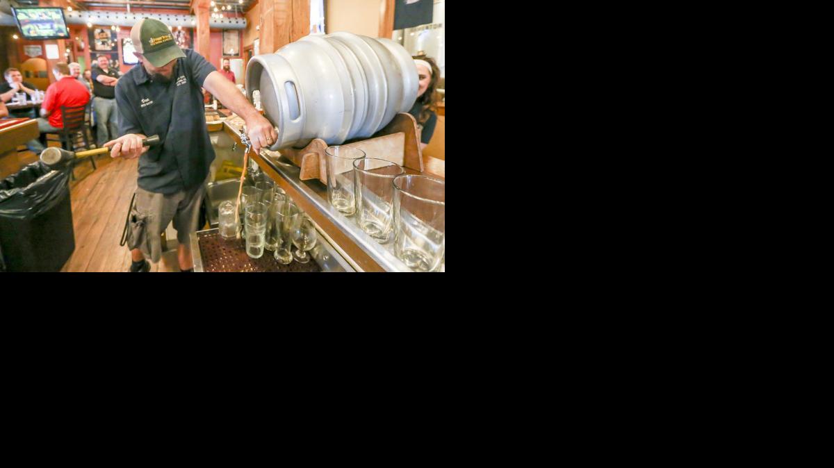 River City brew master Dan Norton taps a firkin at the restaurant. 

