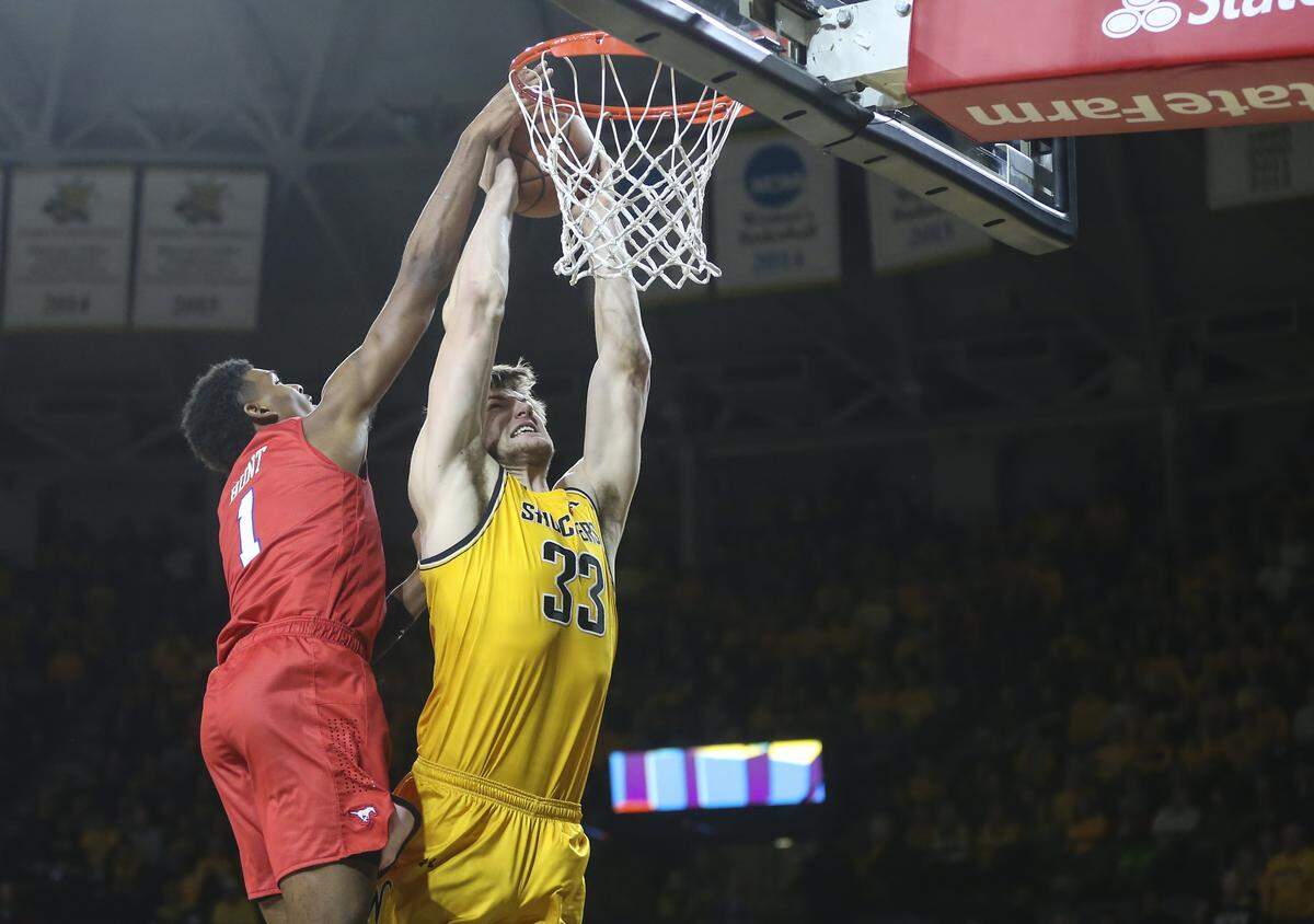 Wichita State center Asbjorn Midtgaard goes to the basket against Southern Methodist forward Feron Hunt during the second half of their game at Koch Arena on Wednesday.