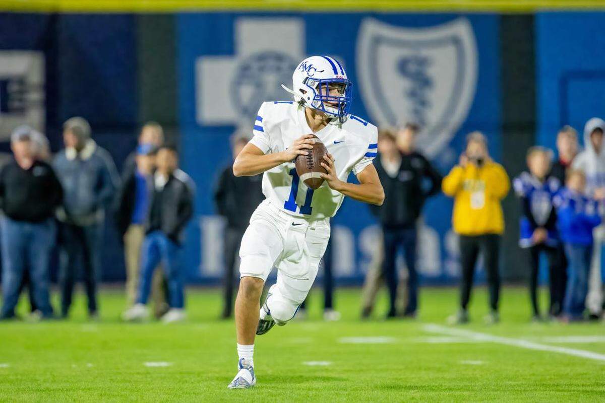 Kapaun Mt. Carmel quarterback Dylan Hamilton threw two touchdowns in the first high school football game played at Riverfront Stadium on Friday.