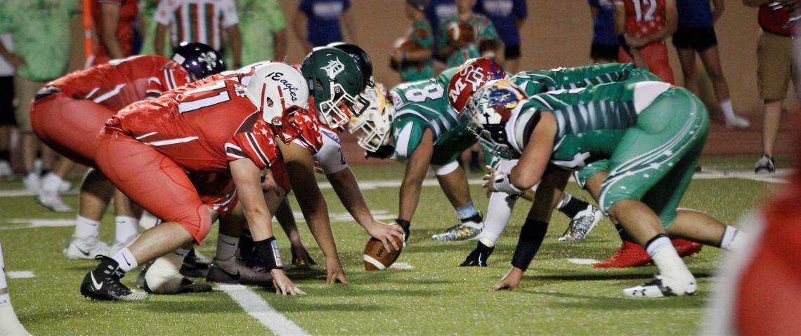 East and West offensive and defensive lines prepare for a clash.
