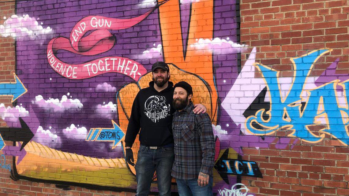 Tulsa artists Daniel Gulick, left, and Anthony Carrera created this mural outside The Workroom at First and Cleveland as part of a nationwide campaign sponsored by TOMS Shoes.