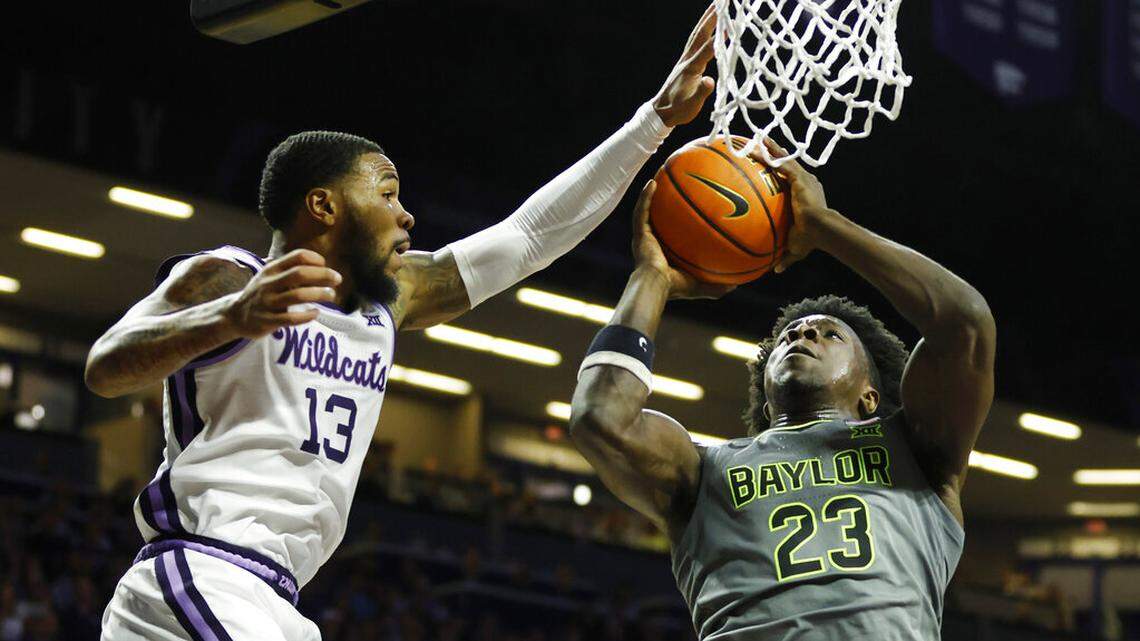 Kansas State guard Desi Sills (left) attempts to block Baylor forward Jonathan Tchamwa Tchatchoua during the first half on Tuesday, Feb. 21, 2023, in Manhattan, Kan.