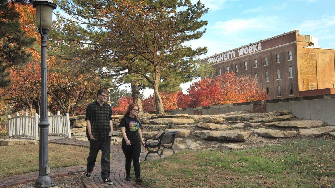 A couple walk through Naftzger Park in Wichita