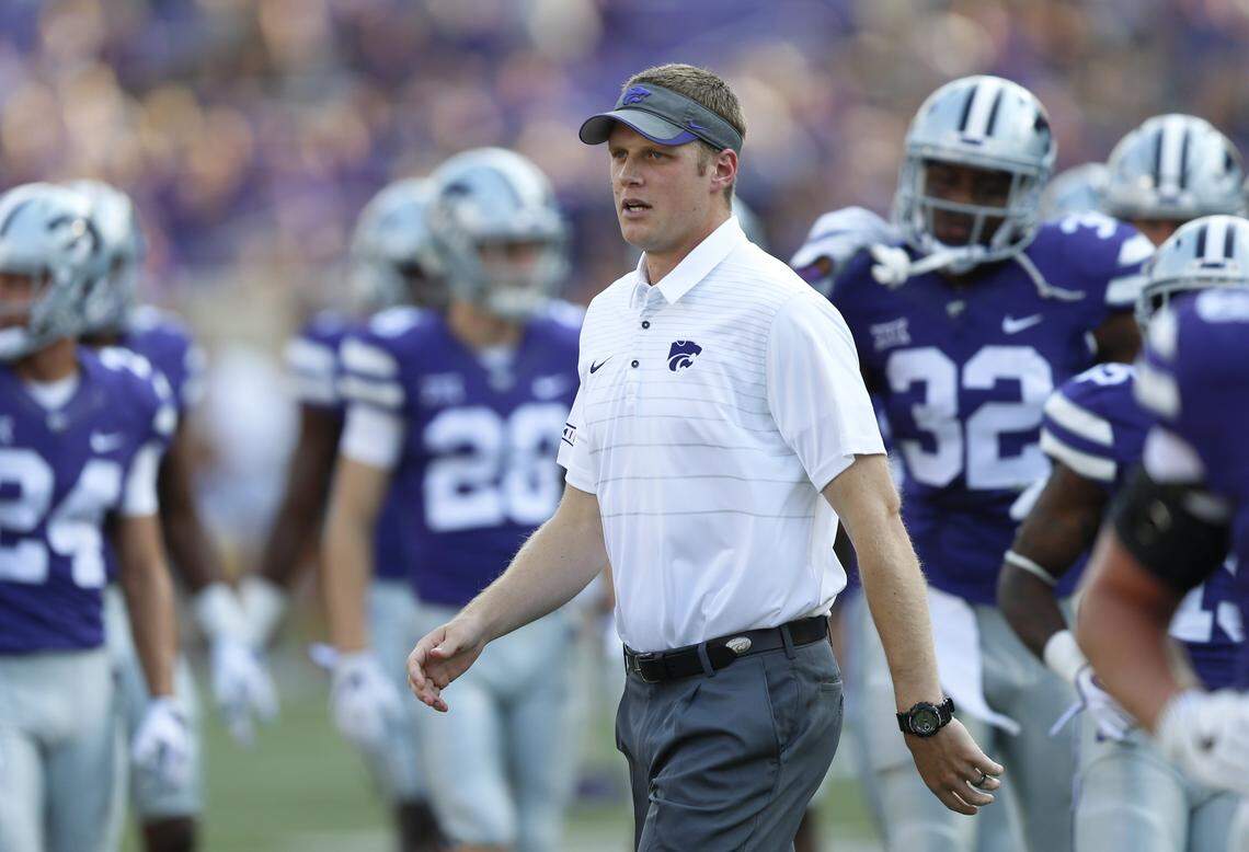 Then-Kansas State assistant coach Collin Klein walks the field during warm-ups in 2018.