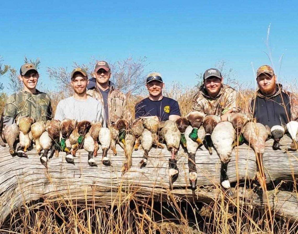 Garrett Schmidt (left), Ty Voth (middle right) and friends smile after a succesful hunt in 2017. Voth, a Wichita firefighter, died Thursday while fighting a house fire.