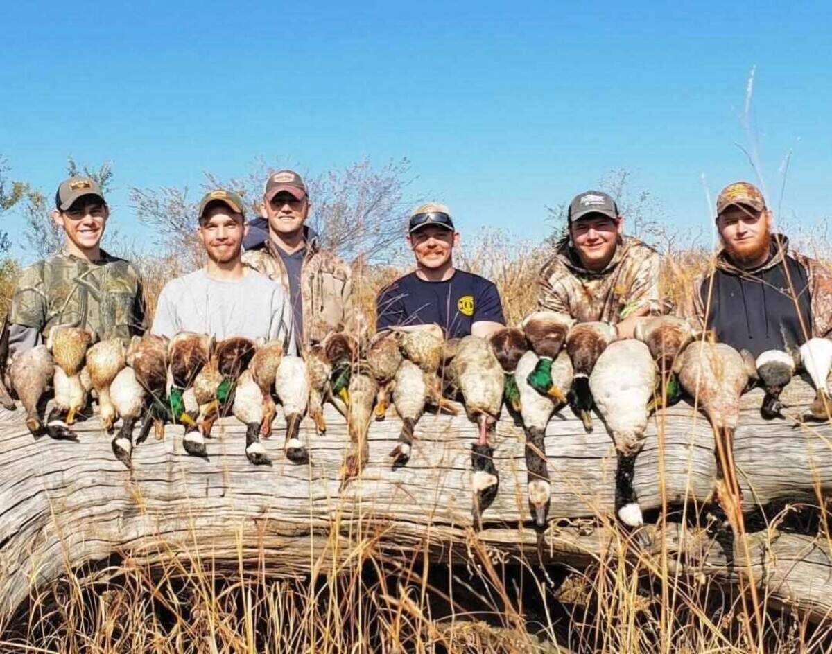 Garrett Schmidt (left), Ty Voth (middle right) and friends smile after a succesful hunt in 2017. Voth, a Wichita firefighter, died Thursday while fighting a house fire.