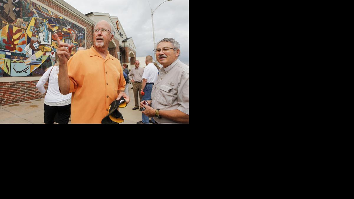 Abode Venue owner Bill Jackson, left, talks with his neighbor Spice Merchant owner Bob Boewe after the unveiling of a mural by Steve Murillo and Margi Sweeton at his venue Friday. (June 27, 2014)

