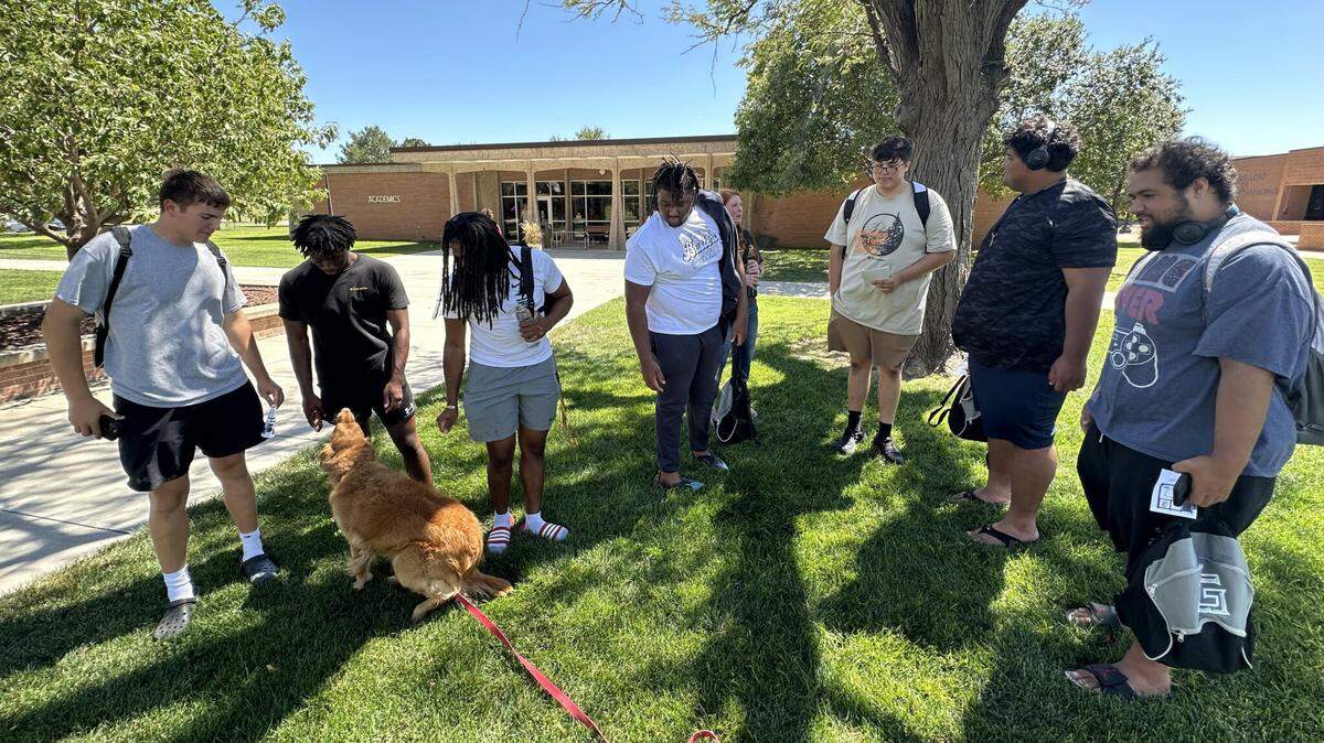 New students at Garden City Community College pet Aspen the comfort dog during fall semester orientation on Aug. 18, 2024. Community colleges across Kansas are reporting increased numbers of students living on campus.